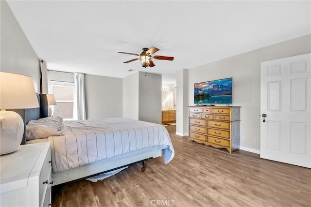 bedroom featuring ceiling fan, wood-type flooring, and connected bathroom