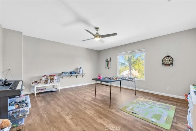 recreation room with ceiling fan and wood-type flooring