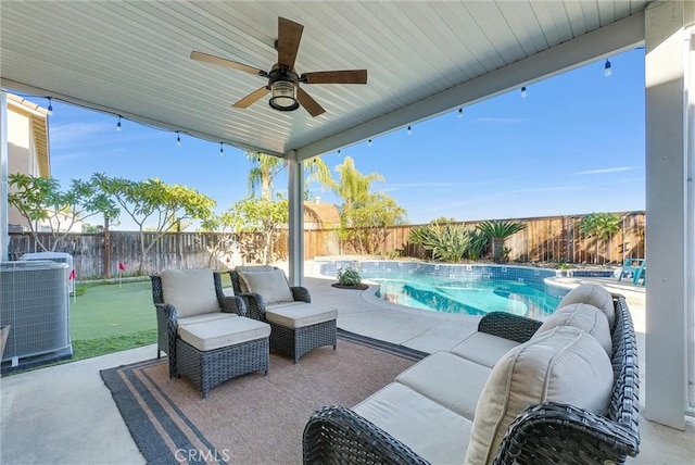 view of patio featuring a fenced in pool, ceiling fan, and central AC unit