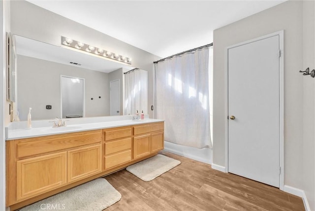 bathroom with vanity, hardwood / wood-style flooring, and shower / tub combo with curtain