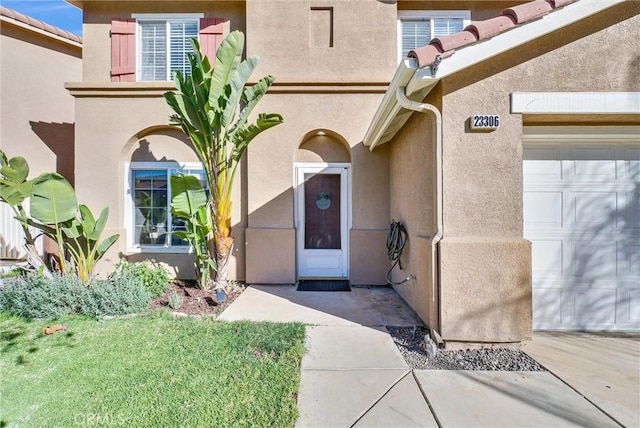 view of exterior entry featuring a garage