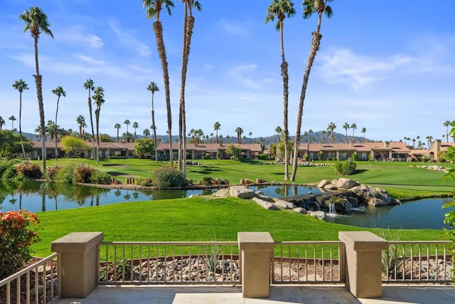 view of community with a water view and a yard