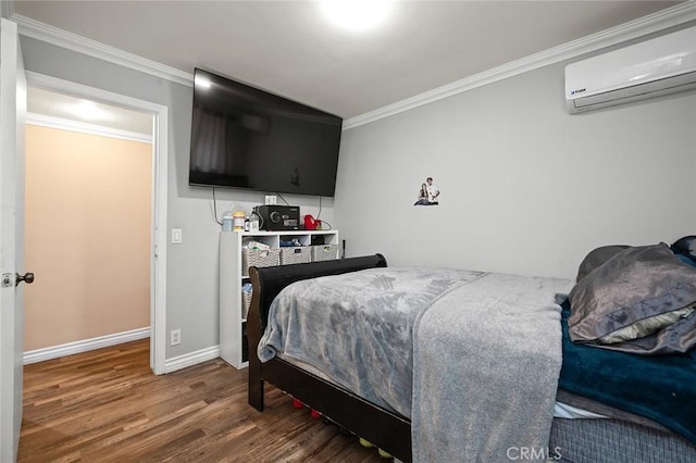 bedroom with a wall unit AC, crown molding, and hardwood / wood-style floors