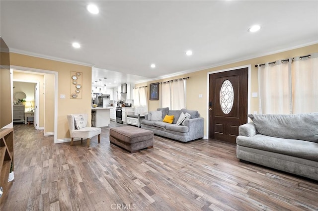 living room with light wood-type flooring and crown molding