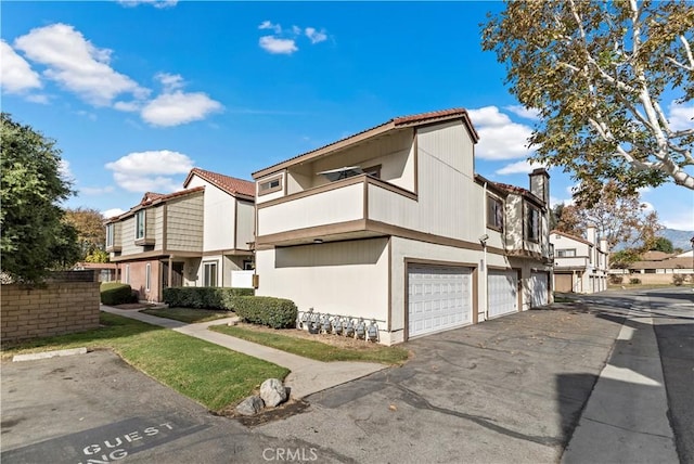 view of front of property with a garage and a balcony