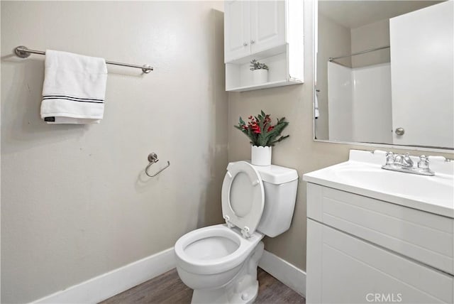 bathroom featuring vanity, hardwood / wood-style flooring, toilet, and walk in shower