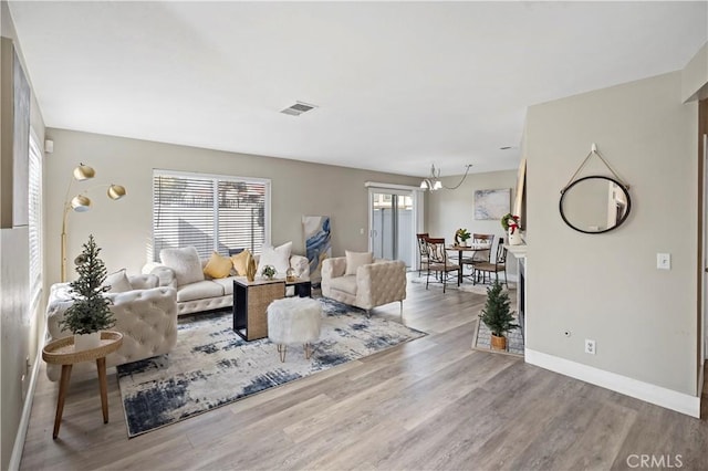 living room featuring hardwood / wood-style floors and an inviting chandelier