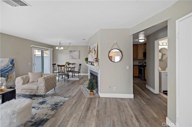 living room featuring light hardwood / wood-style floors and an inviting chandelier