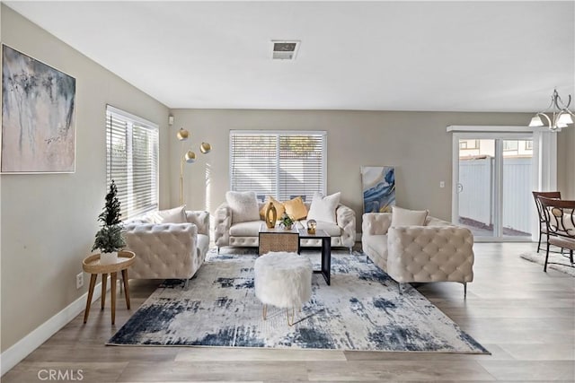 living room featuring hardwood / wood-style floors and an inviting chandelier