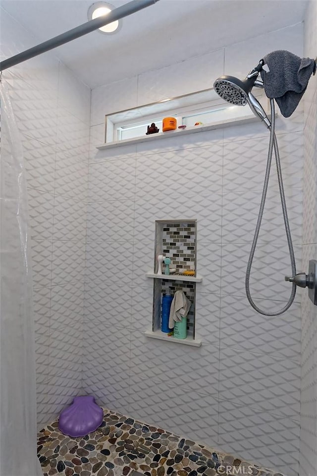 bathroom with tiled shower