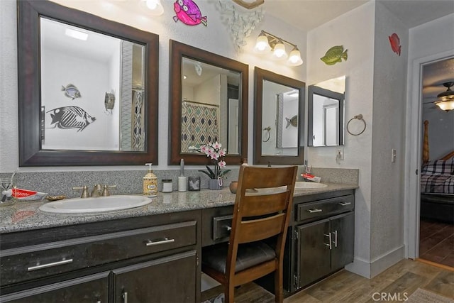 bathroom featuring hardwood / wood-style floors, vanity, and ceiling fan