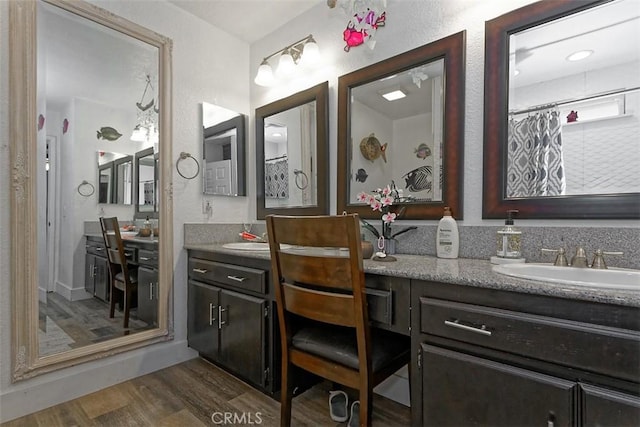 bathroom with hardwood / wood-style floors, vanity, and a shower with shower curtain