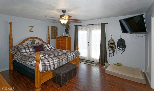 bedroom featuring ceiling fan, dark wood-type flooring, and a textured ceiling