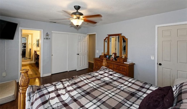 bedroom featuring ceiling fan, a closet, dark wood-type flooring, and ensuite bath