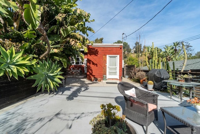 view of patio with a storage shed and grilling area