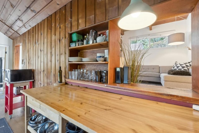 interior space with lofted ceiling and wood walls