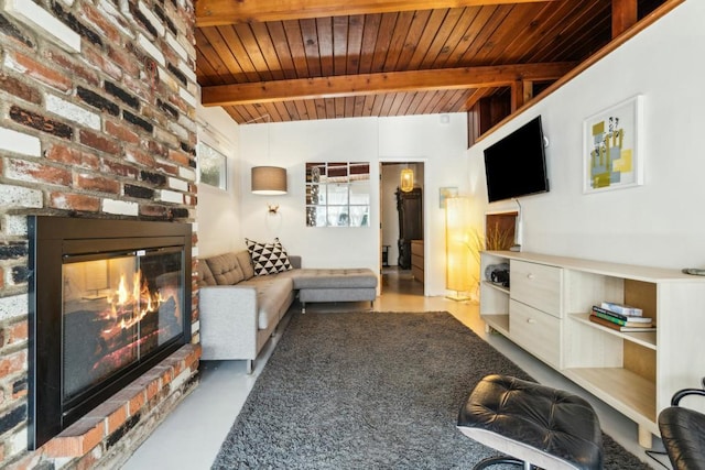 living room with a brick fireplace, beam ceiling, and wood ceiling