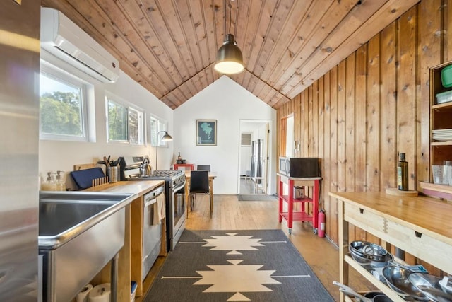 kitchen with wood walls, pendant lighting, a wall mounted air conditioner, stainless steel appliances, and wooden ceiling