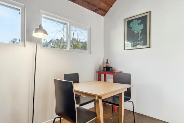 dining room with hardwood / wood-style floors and vaulted ceiling