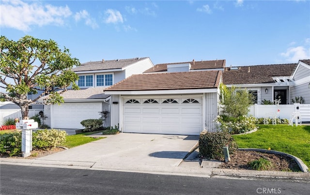 view of front facade featuring a front yard and a garage