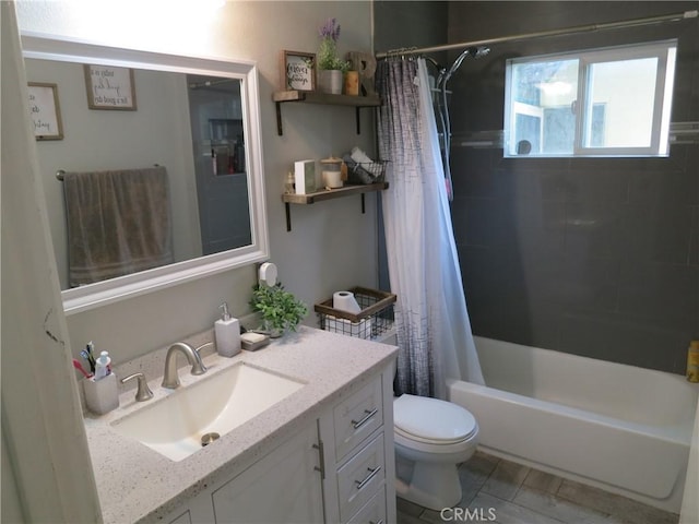 full bathroom featuring shower / bath combo, vanity, and toilet