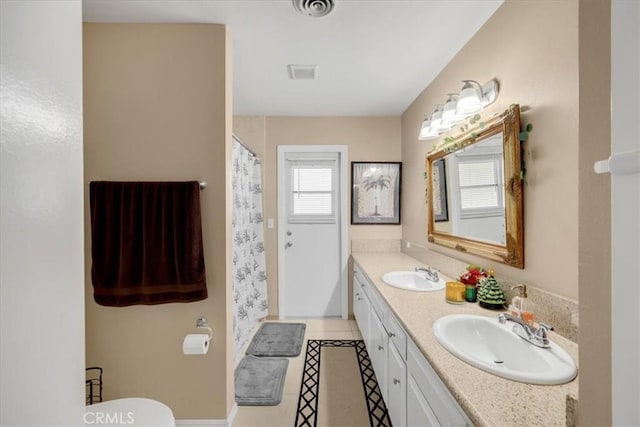 bathroom with a shower with curtain, tile patterned flooring, vanity, and toilet