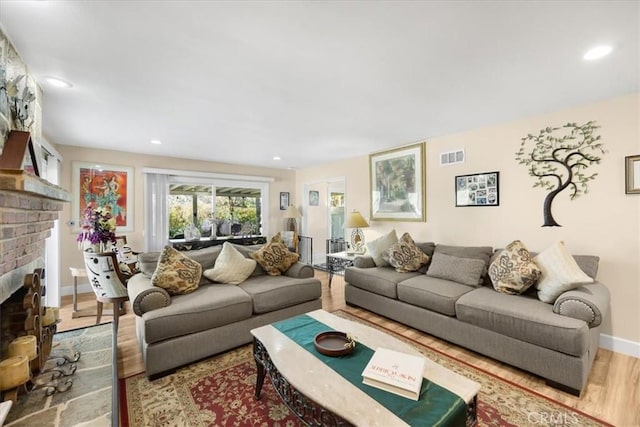 living room with hardwood / wood-style floors and a fireplace