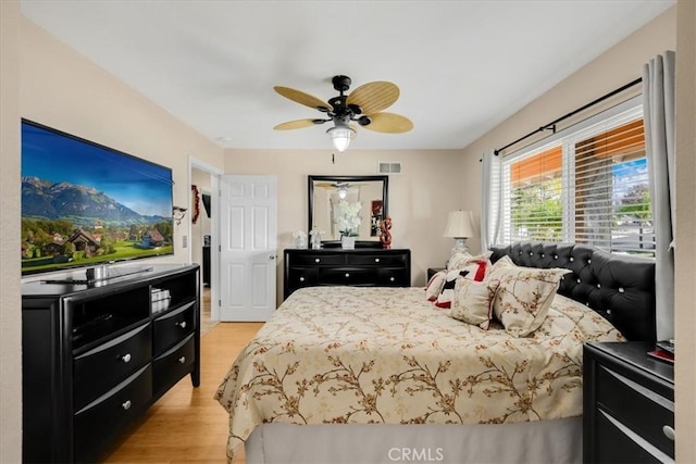 bedroom with light wood-type flooring and ceiling fan