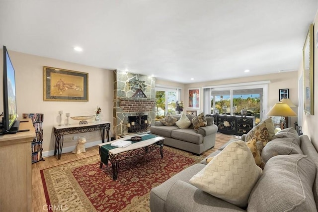 living room with a fireplace and wood-type flooring