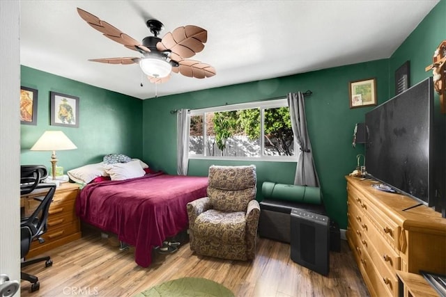 bedroom with ceiling fan and wood-type flooring