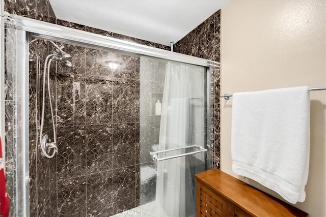 bathroom with a shower with shower door