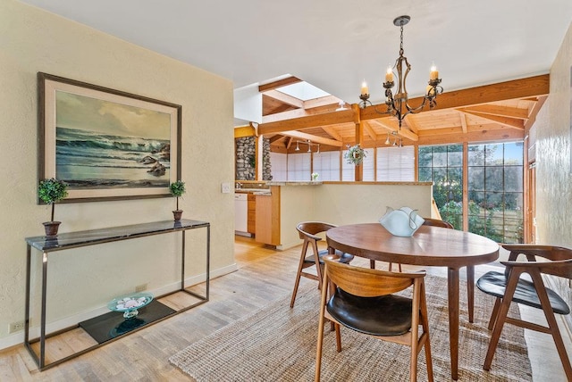 dining space featuring beam ceiling, light hardwood / wood-style flooring, and a notable chandelier