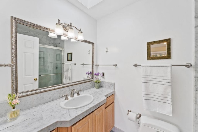 bathroom featuring toilet, vanity, and an enclosed shower