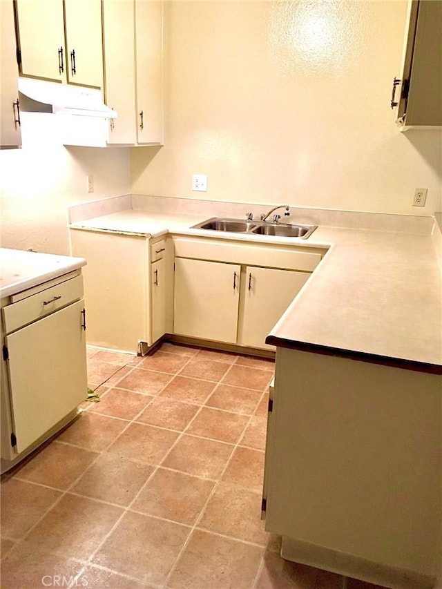 kitchen with light tile patterned floors and sink