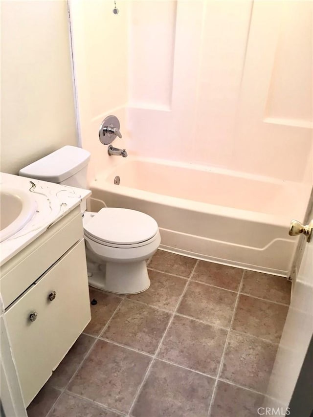 full bathroom featuring tile patterned flooring, vanity, bathing tub / shower combination, and toilet