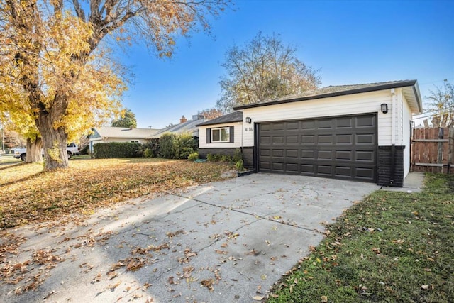 view of front of house featuring a garage and a front lawn