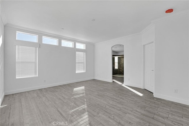 unfurnished room with plenty of natural light and ornamental molding