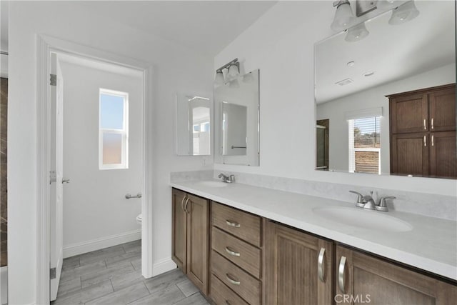 bathroom with hardwood / wood-style flooring, vanity, toilet, and lofted ceiling