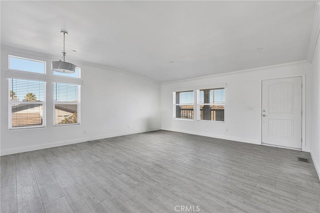 unfurnished living room with light hardwood / wood-style floors and crown molding