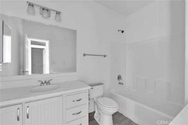 full bathroom featuring hardwood / wood-style floors, vanity, bathing tub / shower combination, and toilet