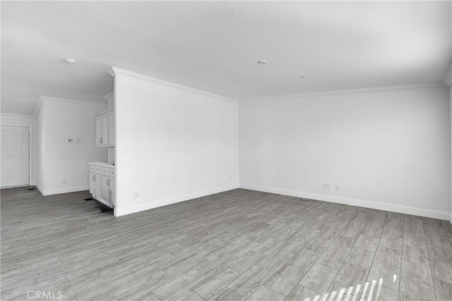 interior space featuring light hardwood / wood-style floors and ornamental molding