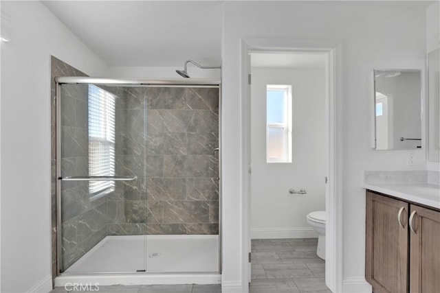 bathroom with vanity, toilet, and an enclosed shower