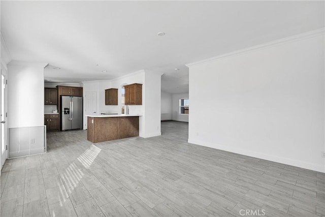 unfurnished living room featuring light hardwood / wood-style flooring and ornamental molding