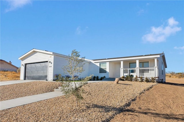 single story home featuring a porch and a garage