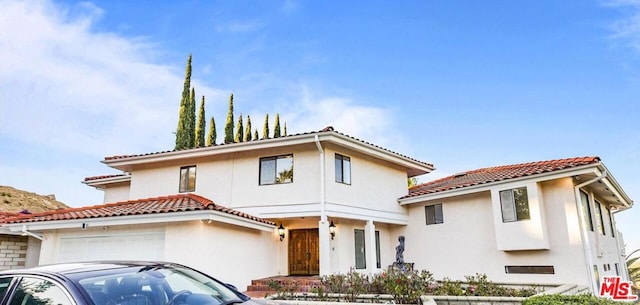 mediterranean / spanish home featuring a garage