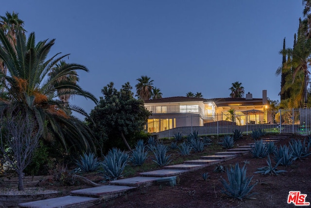 view of back house at dusk