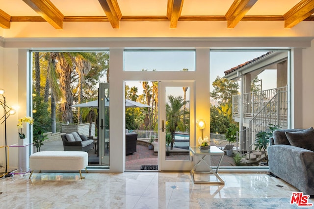 doorway to outside featuring french doors and beamed ceiling