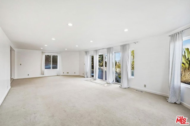 unfurnished room with light carpet