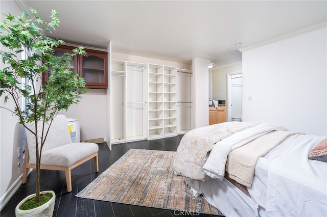 bedroom with crown molding and dark hardwood / wood-style floors