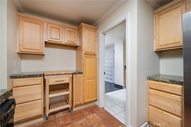 kitchen with crown molding, dark stone countertops, and light brown cabinets